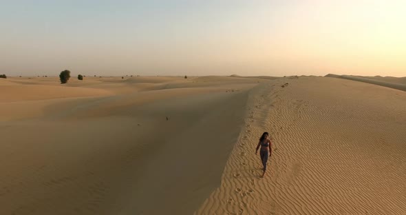 Sports Girl Walks in the Desert