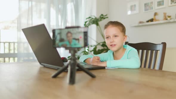 Schoolgirl Girl Doing Homework On Distance Learning alt