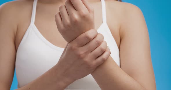 Carpal Tunnel Syndrome. Close Up Shot of Female Hand Touching Sore Wrist, Trying To Stretch Joint alt