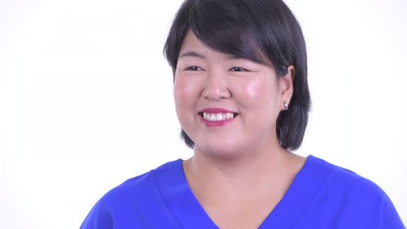 Face of Happy Overweight Asian Businesswoman Thinking alt