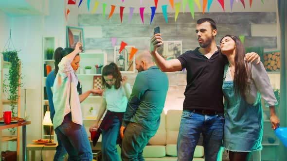 Attractive Bearded Young Man Taking a Selfie with Beautiful Friend alt