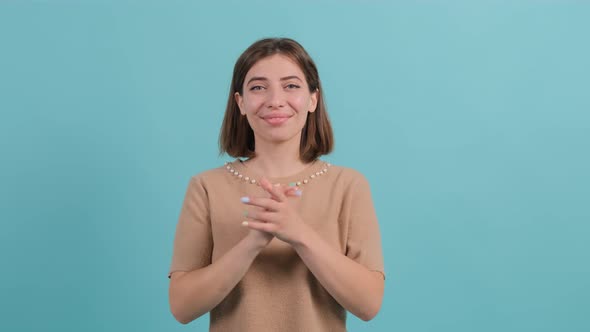 Applauding Young Pretty Girl, Clapping Over Turquoise Background alt