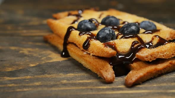 Dolly Shot Belgian Waffle with Blueberries and Chocolate Topping