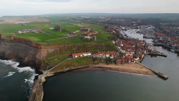 Aerial parallel shot of Whitby, North York Moors, early morning sunshine North Yorkshire Heritage Co alt