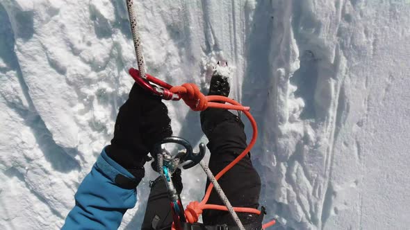 Alpinist Man Is Using Figure of Eight, Abseiling on Fixed Rope alt
