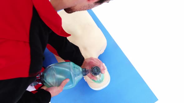 Male paramedic during cardiopulmonary resuscitation training alt