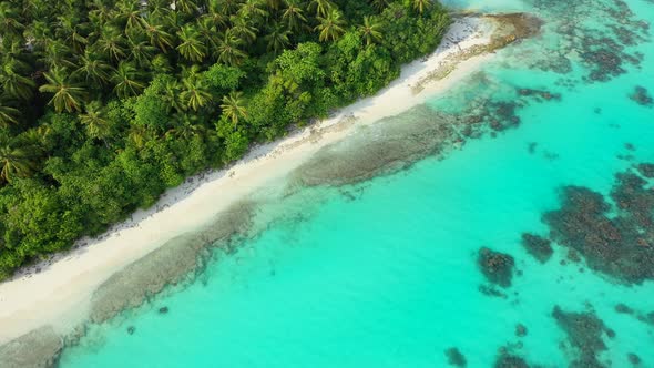 Beautiful fly over island view of a white paradise beach and aqua blue water background alt