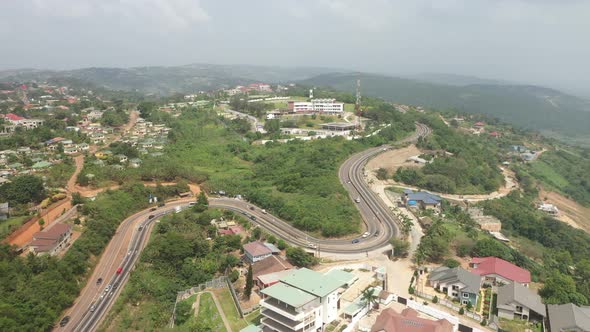 Road on the hill with cars - Aburi, Ghana alt