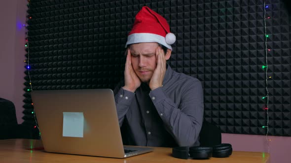 Man at Home Having a Headache in Front of Laptop alt