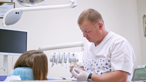Dentist at work in the office. Dentist curing a female patient in the stomatology alt