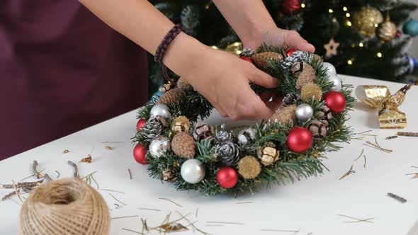 Young Woman Making Decorative Christmas Wreath