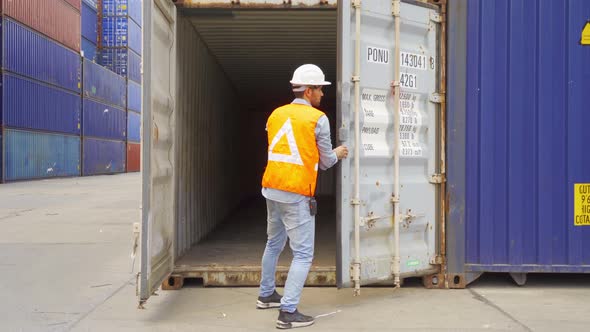 Logistic worker engineer man working in cargo container warehouse industry factory site in export,