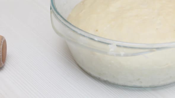 Dough And Cinnamon For Making Cinnabons. Glass Container For Baking. On A White Tabletop alt