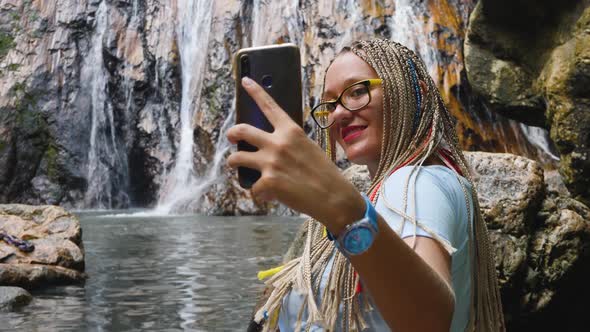 Cute Female Using Smartphone Take Selfie in City Public Park