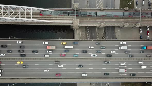 Top Down View of Traffic on a Car and Train Bridge alt