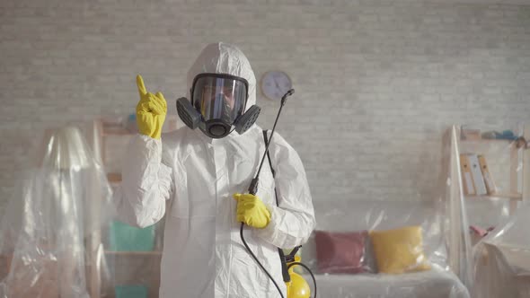 Thoughtful Exterminator Finds a Solution and Looks Into the Camera alt