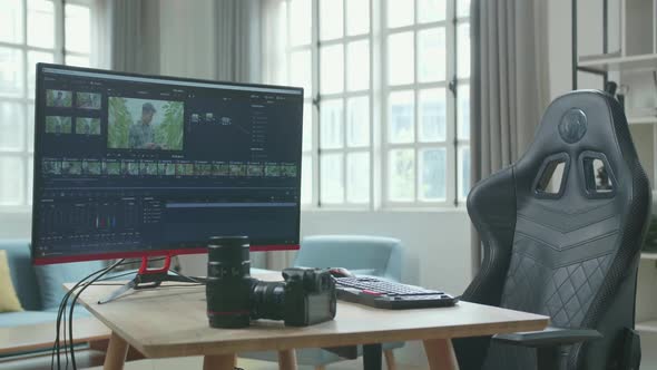 Desktop Computer Showing Video Editing And Camera Is On A Table In The Working Room At Home alt