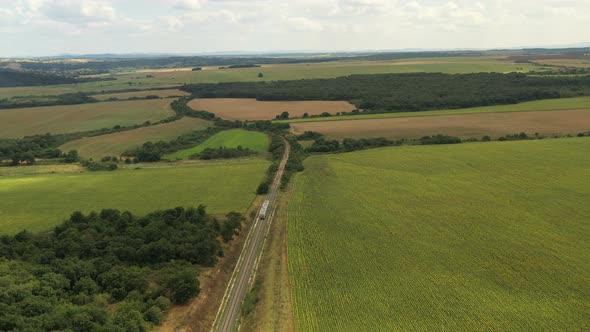 Passenger Train Passes Through Beautiful Farmland alt