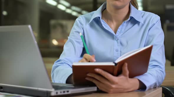Young Woman Writing Ideas in Notebook, Organizing Work Day, Planning Future alt