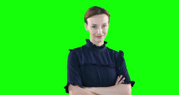 Caucasian woman crossing arms on green background