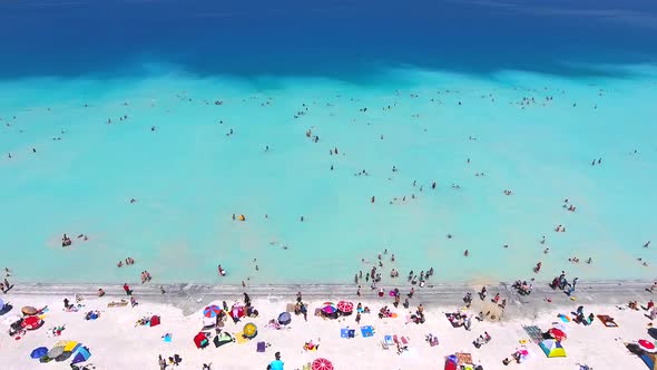 People Swim on Vacation in the White Sandy Beach of the Clear Tropical Turquoise Light Blue Sea alt