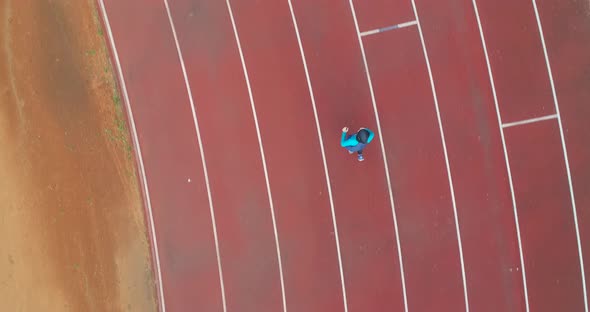 Cinematic Shot of Young Arab Sportswoman with Athletic Body in Hijab Running with Effort and alt