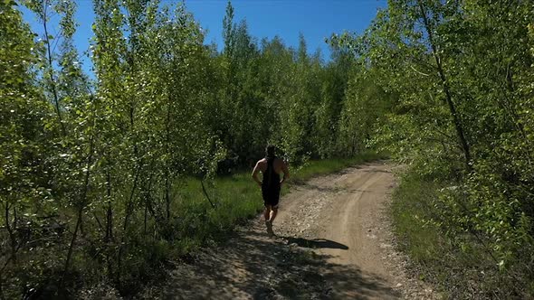 Sportsman Running on Path in Nature