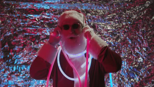 Cool Santa Claus Dancing Illuminated by Neon Light alt