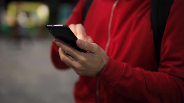 Unrecognizable Person with Smartphone in the Park