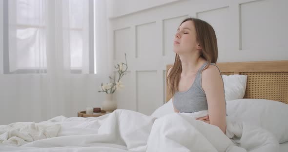 Young Woman Suffering From Stomachache. Her Menstrual Cramps Are Too Painful To Go To Work. Woman alt