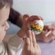Little child draws patterns on an Easter egg - VideoHive Item for Sale