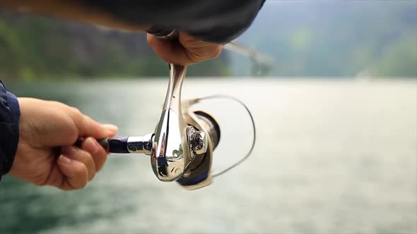 Woman Fishing on Fishing Rod Spinning in Norway alt