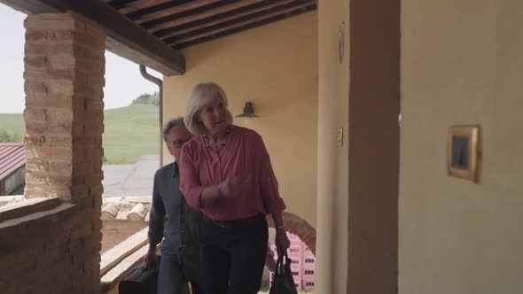 Senior couple arriving at holiday apartment