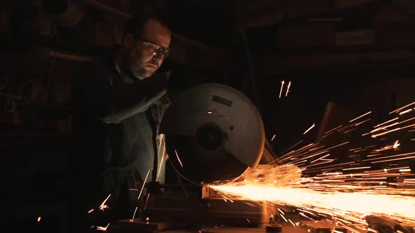 Man Works With Big Electric Grinder. alt