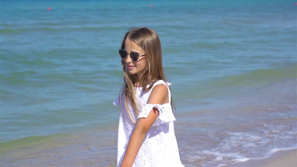 Adorable Little Girl Have Fun at Tropical Beach During Vacation