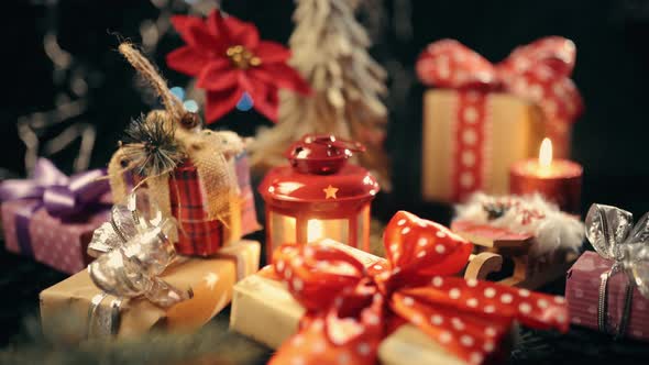 The Hand Is Put a Christmas Gift Box, Christmas Ball on Glow Bokeh Lights Background alt