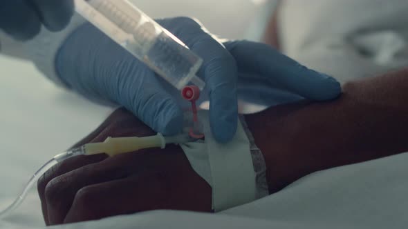 Doctor Putting Patient IV Doing Injection Closeup alt
