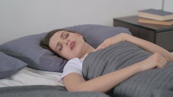 Woman Coughing While Sleeping in Bed alt