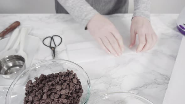 Step by step. Ingredients to prepare chocolate dipped strawberries on a marble surface. alt
