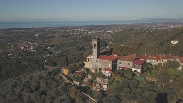 Parallax Drone Shot of Chiesa di Santa di Lucia over the Tuscan Cost and Lido di Camaiore alt