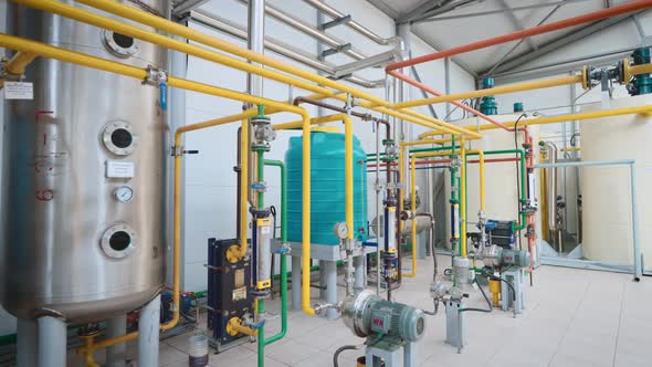 Large Light Workshop with Metal Containers and a Complex Piping System alt