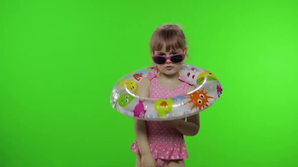 Funny Child Girl in Swimwear Play with Swimming Ring, Make Faces. Vacation Sea alt