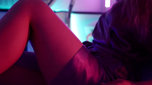 A Young Woman Prepares for a Laser Appeal Lying on a Couch and Puts on Protective Glasses alt