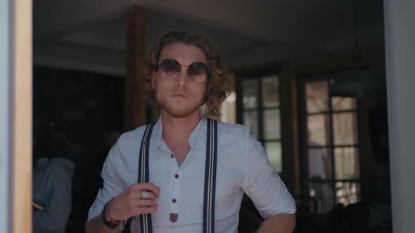 Portrait of a young male model in sunglasses alt
