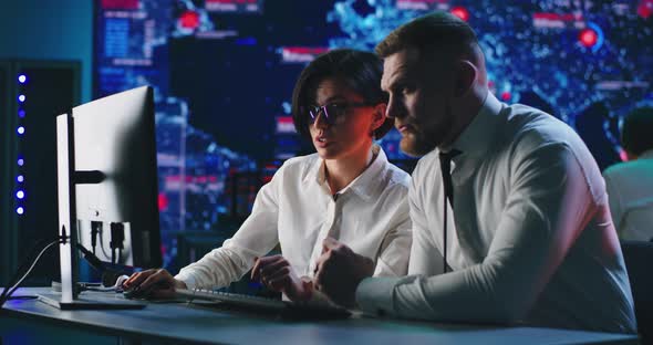 Woman Showing Digital Security Data To Colleague alt