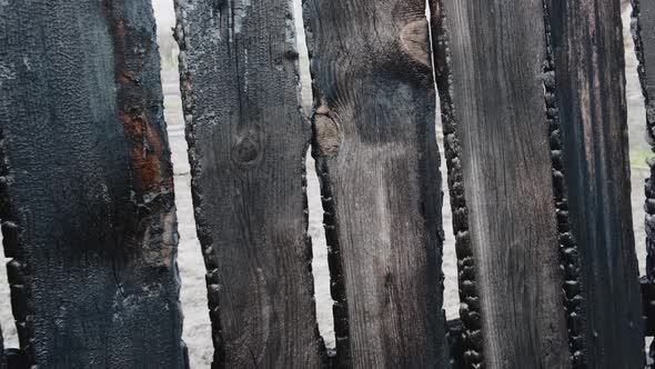 Burnt Fence Boards After a Fire in a Private House alt