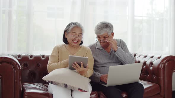Senior couple using technology device at home