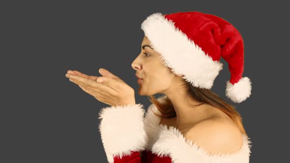 Sexy santa girl blowing over hands alt