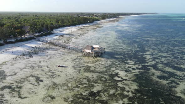 Aerial View of a House on Stilts in the Ocean on the Coast of Zanzibar Tanzania Slow Motion alt