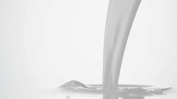 Pouing milk and making splash. Slow Motion. alt